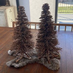 Two handcrafted branch stick trees. Natural outdoor Christmas decor.